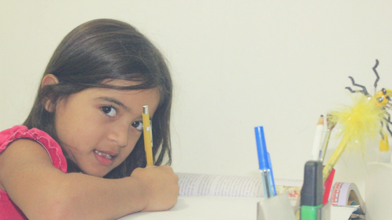 Homeschooled Girl Sitting Working With Her Text Book