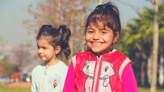 Two Cheerful And Smiling Little Girls