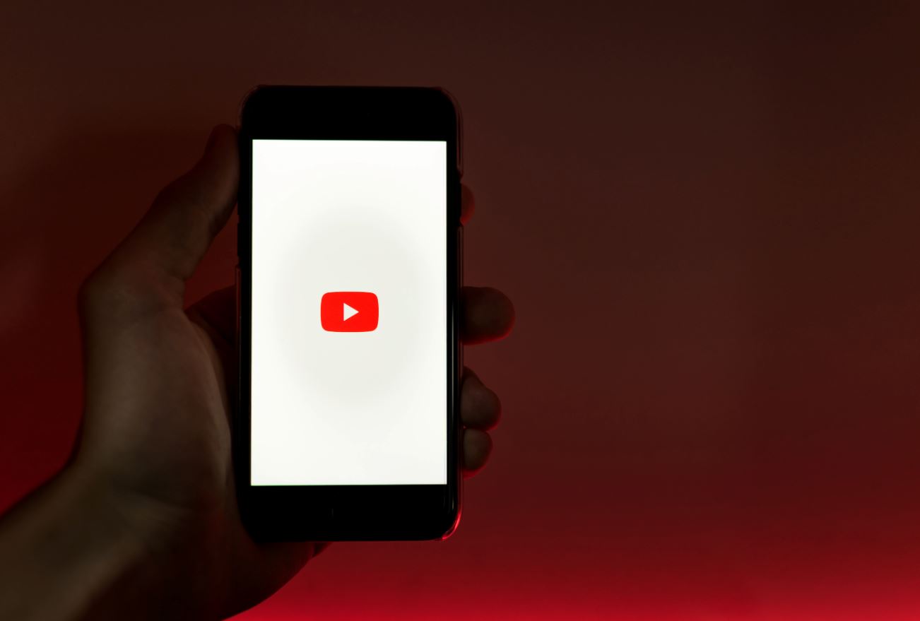 Hand Holding A Smartphone Open On YouTube