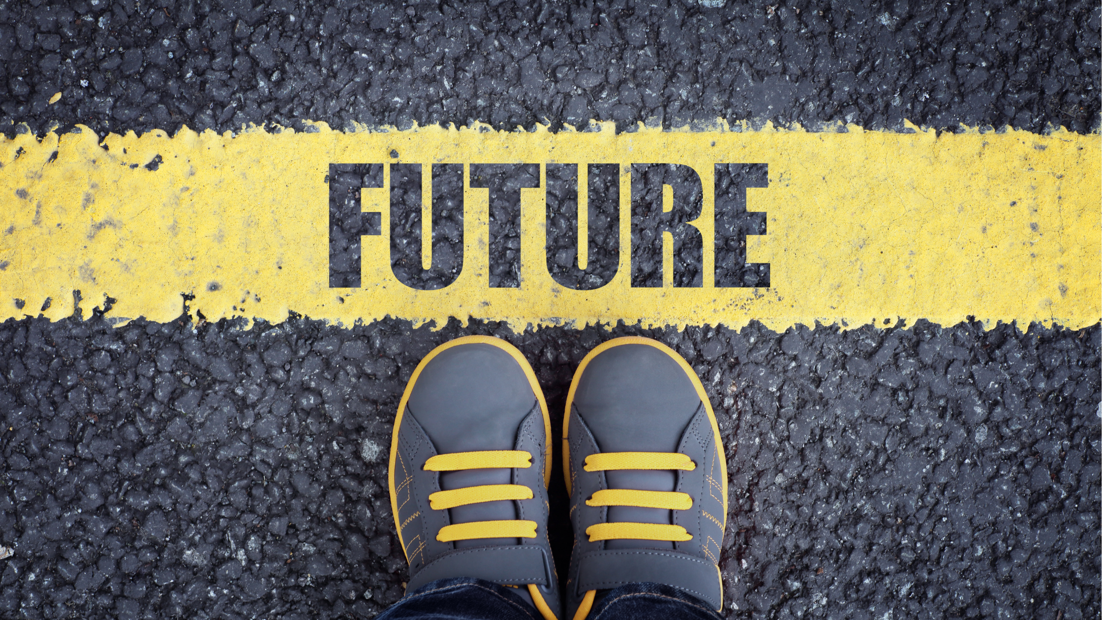 Grey And Yellow Shoes Standing Behind A Yellow Line Reading Future On The Road